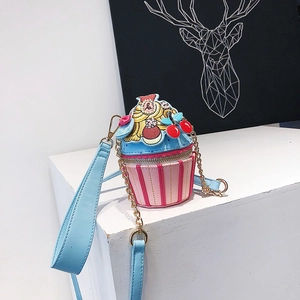 Close-up of creative cupcake-shaped girls crossbody bag with blue cream and pink stripes