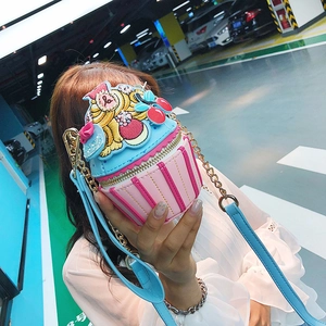 Detail of creative cupcake-shaped crossbody bag with pink stripes and blue cream topping