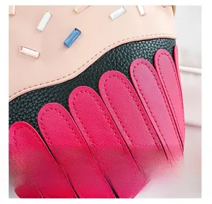 Detail of creative cupcake bag showing pink leather with rhinestones and precise stitching
