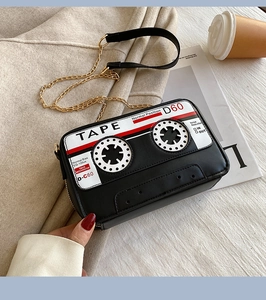 Detailed view of the vintage cassette tape design on this black crossbody chain bag