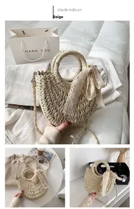 Detail of beige straw bag with round handle, woven strap and white lace scarf decoration