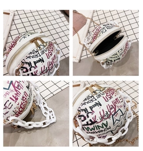 Macro view of white basketball bag with colorful graffiti prints and gold double zippers