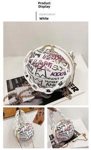 Detail of white basketball shaped bag with colorful graffiti and gold metal chain strap