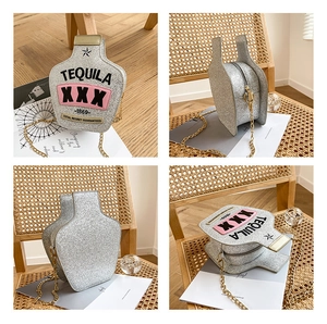 Detail of silver sequin tequila bottle shaped crossbody bag with gold chain strap