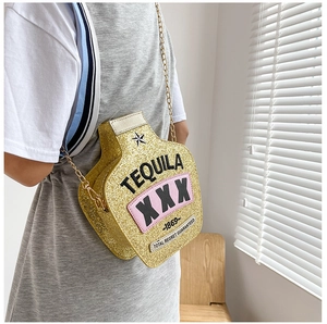 Macro shot of a tequila bottle-shaped crossbody bag with golden glitter and chain strap