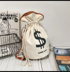 Detail of canvas drawstring bucket bag with leather trim and branded logo print