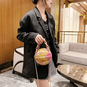 Graffiti basketball shaped crossbody bag with pink chain strap and artistic patterns