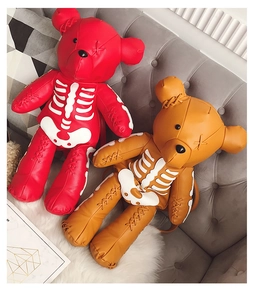 Detail of red and orange PU leather bear backpacks with unique skeleton stitching design