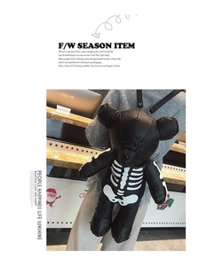 Detail of black PU leather bear backpack with white skeleton print worn by a model