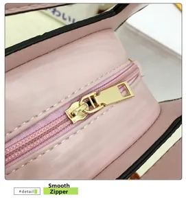 Vue macro de la fermeture éclair dorée lisse et des coutures sur un sac rose