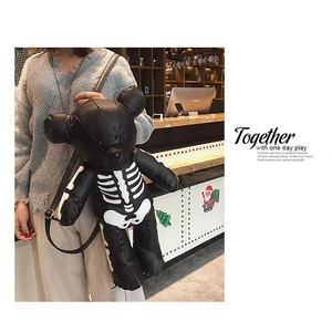 Detailed view of black PU leather bear backpack with white skeleton print and straps