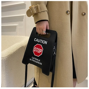 Détail du sac à bandoulière insolite STOP avec coupe géométrique et poignée intégrée