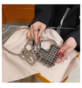 Close-up of metallic heart-shaped beaded mini bag with chain strap in dark silver finish