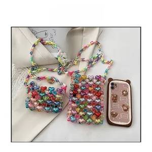 Detail of colorful handmade beaded heart crossbody bags with rainbow plastic chains