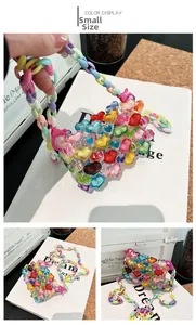 Detail of colorful acrylic heart-shaped beaded mini bag with trendy plastic chain handle
