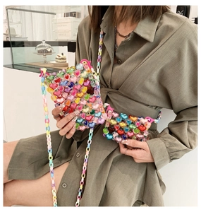 Detail of colorful acrylic heart beaded bag with mini pouch and circular chain strap