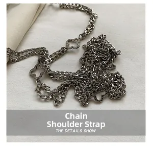 Macro shot of silver metal chain shoulder strap with rhinestone clover charms