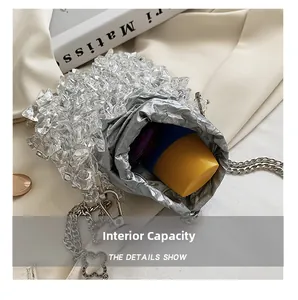 Detail view of mini acrylic bucket bag showing spacious interior with cosmetics