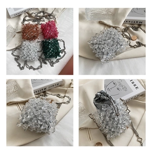 Detail view of mini beaded chain bags with acrylic beads and drawstring inner pouches