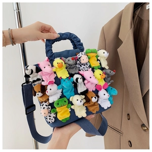 Detail of navy canvas bag featuring various colorful mini plush animal dolls and ruffles
