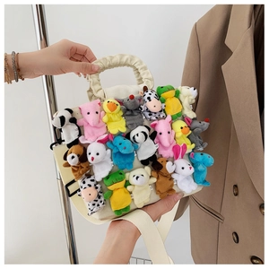 Detail of canvas tote bag featuring multiple cute mini plush animal dolls and ruched handles