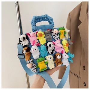 Detail of light blue canvas tote bag with colorful plush animal finger puppets decoration