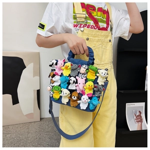Detail of denim bag covered with multiple cute animal plush finger puppets as decoration