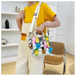 Detail of white tote bag with colorful stuffed animal plush dolls and ruffled handle