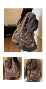 Macro detail of brown knit tote bag with white pearls and luxury fringe trim