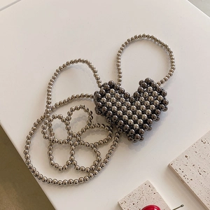 Mini heart-shaped silver metallic beaded crossbody bag with elegant pearl-style chain