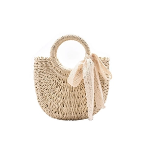 Handwoven straw tote bag in creamy beige featuring a half-moon shape and lace ribbon bow