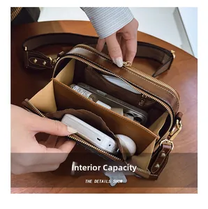 Detail view of the brown leather bag's organized multi-layer accordion compartments