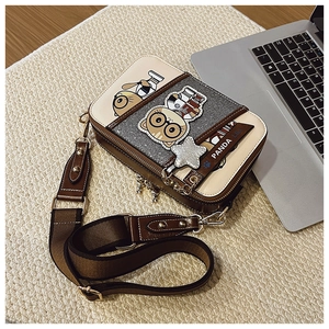 Detail view of cartoon panda crossbody bag with wide strap and double zipper closure