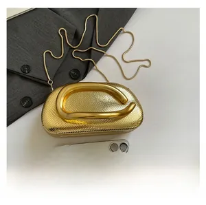 Golden snakeskin embossed evening bag with metal handle and phone for size reference
