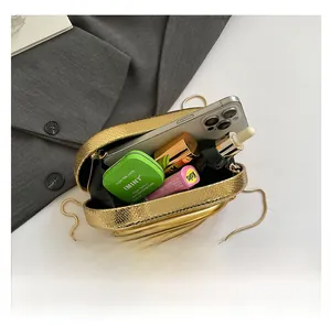 Top view of gold textured clutch showing interior space for phone and cosmetics