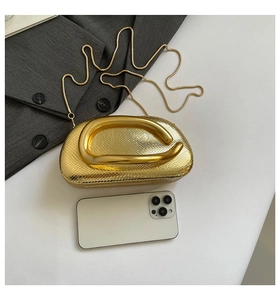 Size comparison of a gold snake-textured metal clutch bag with a smartphone