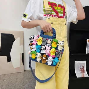 Blue denim tote bag decorated with colorful plush animal finger puppets and shoulder strap