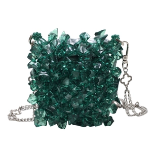 Emerald green acrylic woven mini bag with silver chain strap and clover charm