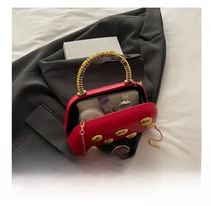 Binnenzicht van de rode avondtas met ruimte voor een telefoon en make-up artikelen