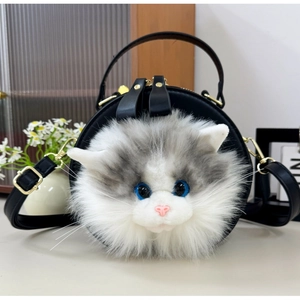 Close-up of circular black leather handbag featuring a realistic 3D plush cat face design