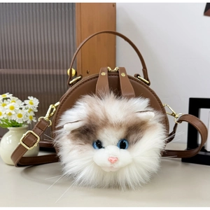 Detail of cute brown leather cat crossbody bag with plush cat face and golden hardware