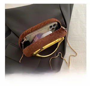 Internal view of velvet clutch bag showing capacity for phone, lipstick and earbuds