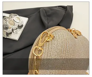 Detail of high-quality gold hardware and sequin texture on heart-shaped evening bag