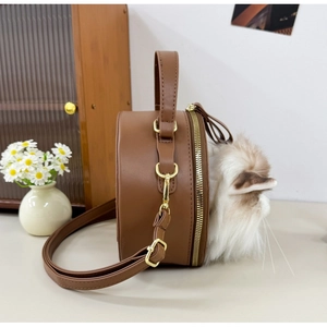 Detail of round plush brown cat purse with faux fur ears and adjustable shoulder strap