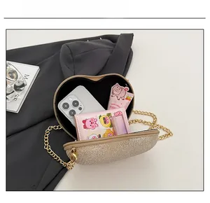 Macro view of heart-shaped crossbody bag capacity with glitter surface and chain