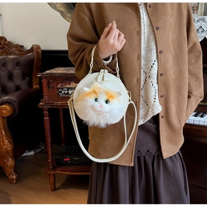 Close-up of circular white leather bag featuring a 3D plush orange cat face detail
