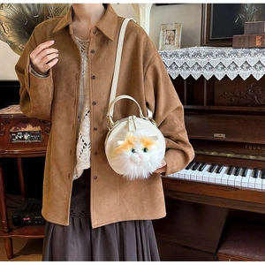 Detail showing a white round cat crossbody bag worn with vintage brown shirt and skirt