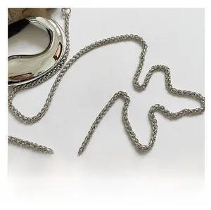 Detailed close-up of a silver braided metal chain strap for women evening bag