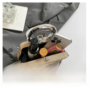 Macro view of sequin evening bag interior showing phone, makeup, and silver metal handle