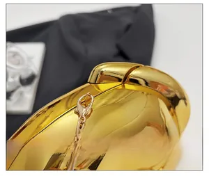 Detail of premium gold mirror evening bag showing high-quality metallic chain attachment